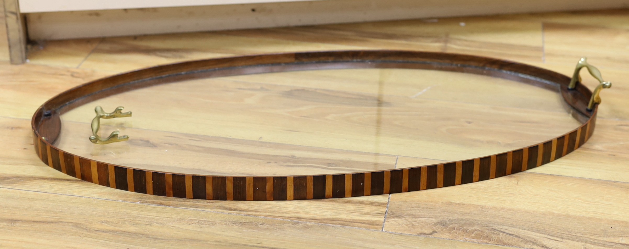 An early 20th century rosewood and satinwood banded glass tray
